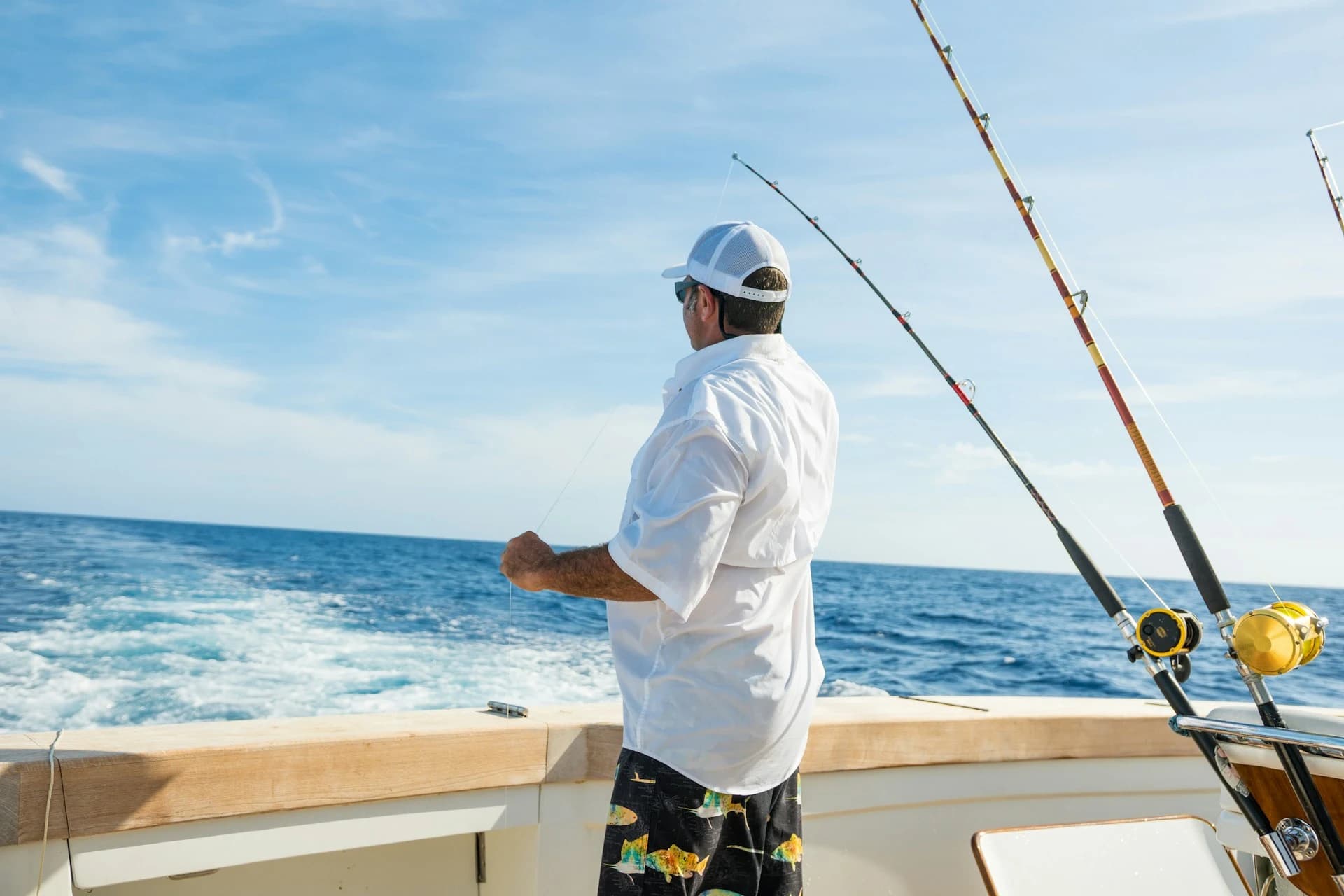 Sportfishing boat with outriggers trolling a spread in deep blue water off Punta Cana